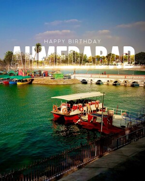 Kankaria Lake in Ahmedabad with boats and a 'Happy Birthday Ahmedabad' text overlay.