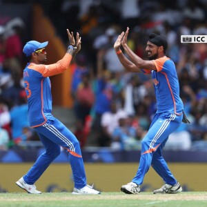 Two Indian cricketers celebrating a wicket during a match